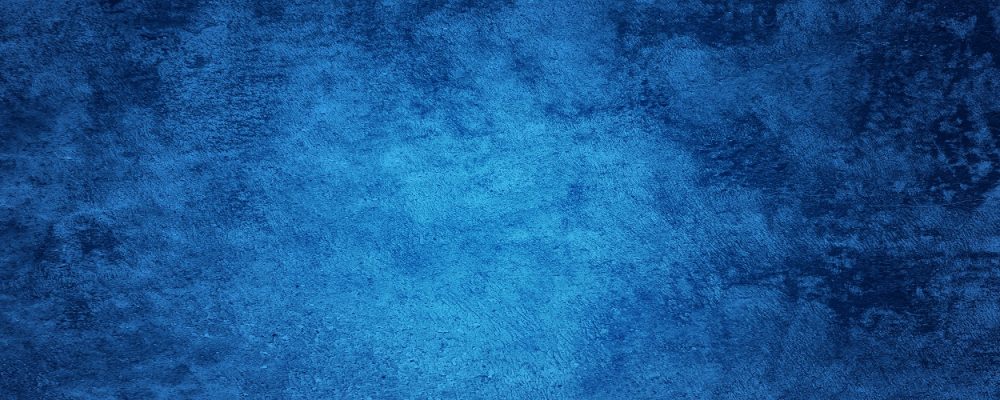 Abstract Grunge Decorative Relief Navy Blue Stucco Wall Texture. Wide Angle Rough Colored Background With spot light